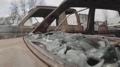 Broken-and-Melted-Car-Windshield-of-a-Rusty-Sedan---Aftermath-of-a-Wildfire---4K