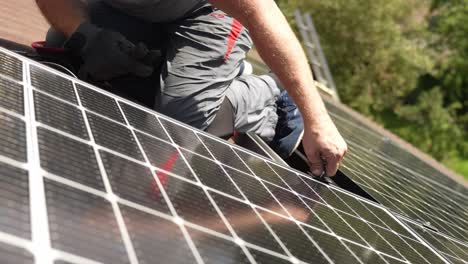 Solar-panel-installation-by-hand-on-civilians-house,-sustainable-energy