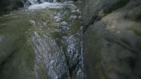 Slow-motion-footage-of-water-streaming-between-two-rocks