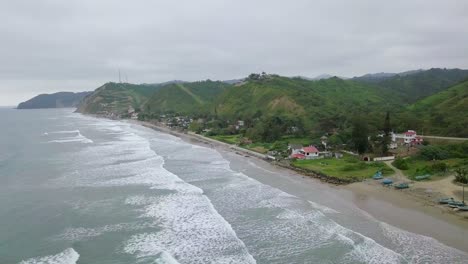Aerial-drone-view-of-waves-splashing-at-the-shore-of-Olon-beach-in-Ecuador