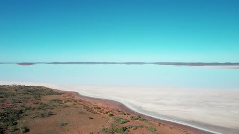 White-colored-Lake-Gairdner,-Beautiful-scenery-from-Salt-large-lake,-Australia,-Drone-flying-backwards