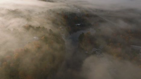 Flying-On-Sherbrooke-Town-Covered-With-Foggy-Clouds-During-Autumn-Season-In-Quebec,-Canada