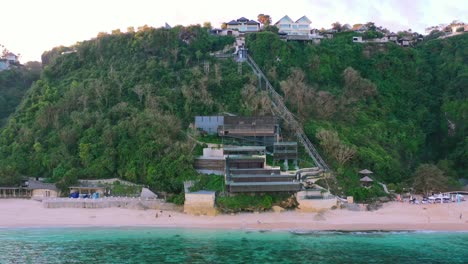 aerial-of-beachfront-homes-on-cliffs-of-Uluwatu-in-Bali-Indonesia-during-sunset