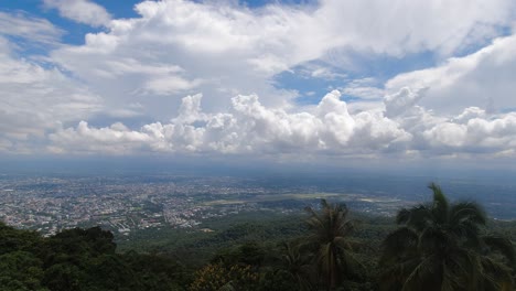 Beautiful-panoramic-view-over-green-lush-jungle-with-city-panorama-in-distance