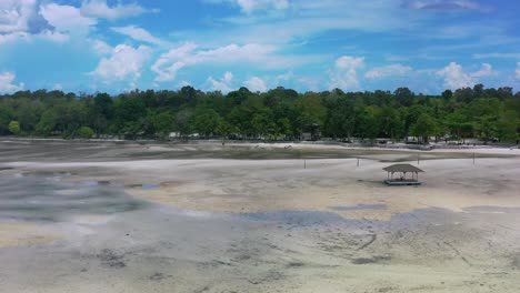 wide-aerial-of-gazebo-at-low-tide-on-coastline-of-Leebong-island-in-Belitung-Indonesia-on-sunny-day