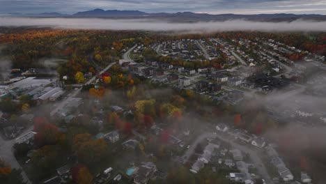 Buildings-And-Autumn-Trees-Through-Strips-Of-Clouds-In-Sherbrooke,-Quebec,-Canada-During-Fall-Season