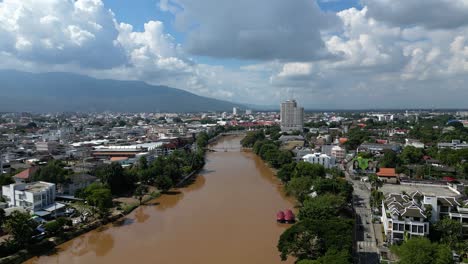 Slow-aerial-forward-flight-over-Ping-River-in-Chiang-Mai,-Thailand