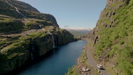 Car-Driving-On-Scenic-Road-Røldalsfjellet-With-View-Of-Waterfall-In-Skare,-Norway