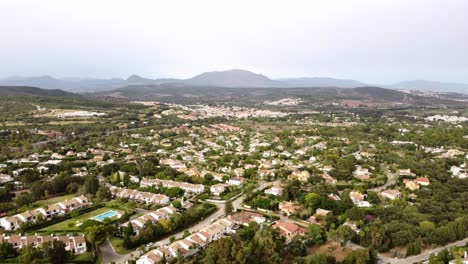 Drone-shot-panning-left-over-town-in-hills-and-countryside-of-Spain