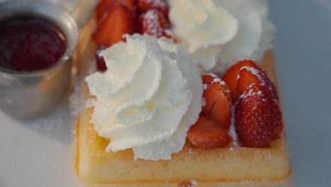 Top-down-of-waffles,-strawberries,-whipped-cream