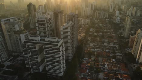 Panning-aerial-drone-shot-of-sky-scrapers-in-Brooklyn,-Sao-Paulo,-Brazil,-Sun-set,-Golden-hour