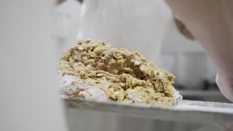 Close-up-handheld-shot-of-a-dough-mass-for-candy-being-stacked-on-top-of-each-other-being-made-in-a-candy-factory-in-Medina-Sidonia-by-the-bakers