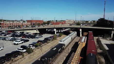 Drone-captures-the-video-of-the-freight-train-or-cargo-train-carrying-multiple-coaches-and-numerous-car-can-be-seen-parked-on-the-side-and-overhead-bridge