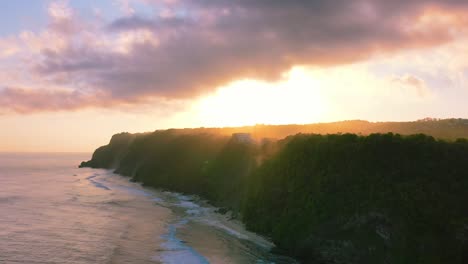 aerial-of-waves-crashing-on-Uluwatu-Cliffs-with-magical-sunset-over-in-Bali-Indonesia