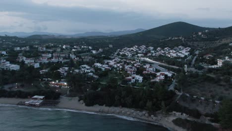 Drone-shot-over-houses-and-the-beach-at-the-evening-in-Greece
