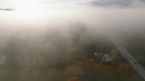 Foggy-Atmosphere-Over-Countryside-Road-And-Colorful-Trees-During-Autumn-In-Sherbrooke,-Quebec-Canada