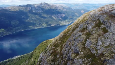 Revealing-Hardangerfjord-sorfjorden-from-majestic-high-altitude-mountain-hillside-above-Lofthus-Norway---Aerial-from-Queens-hiking-trail-looking-towards-Kinsarvik-and-Utne