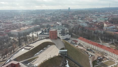 AERIAL:-Reveal-Shot-of-Vilnius-Gediminas-Tower-and-Old-Town-on-a-Bright-Spring-Day