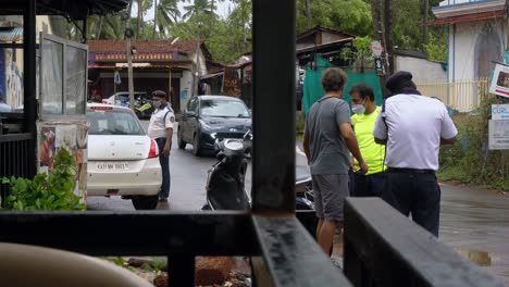 Foreign-Tourists-Stand-Roadside-During-Traffic-Stop-by-Indian-Police-Officers