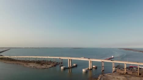 Aerial-approach-of-the-bridge-over-the-Gulf-Intercoastal-Waterway-shipping-channel-on-JFK-Causeway-at-southern-end-of-Corpus-Christi-Bay-in-Texas-Texas