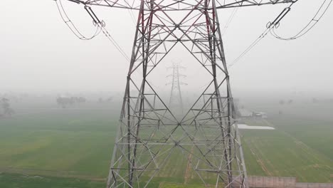 Aerial-view-of-multiple-electric-towers-transmitting-current-are-placed-in-the-fields-in-Punjab