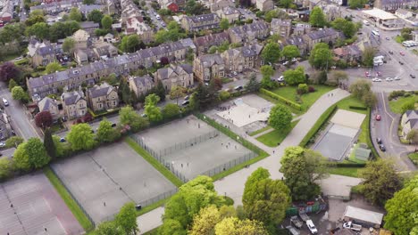 Aerial-shot-flying-over-tennis-club-and-courts-in-English-housing-estate
