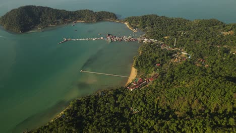 Expansive-aerial-tilt-high-above-the-coast-of-Koh-Chang,-Thailand-with-Bang-Bao-pier-in-the-distance
