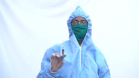 Doctor-in-PPE-kit-blue-protective-suit,-surgical-mask-latex-gloves