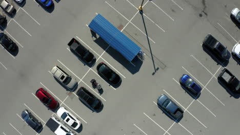 Ascending-aerial-view-over-a-half-empty-supermarket-parking-lot