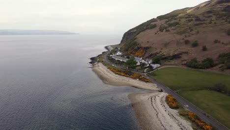 Aerial-view-of-the-Scottish-town-of-Catacol-on-the-Isle-of-Arran-on-an-overcast-day,-Scotland