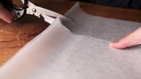 slow-motion-of-cutting-tracing-paper-using-scissors-close-up-macro-shot