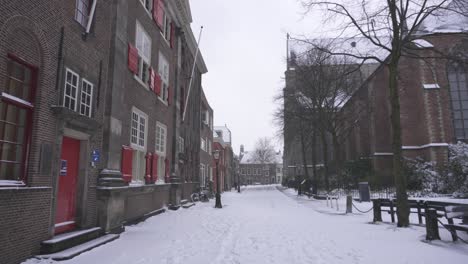 Point-of-view-shot-walking-through-snowy-city-streets,-Leiden-Netherlands