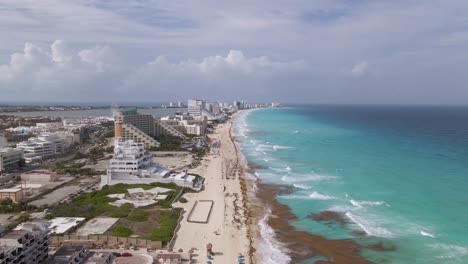 Aerial-forward-along-Cancun-coastline-and-luxury-hotel