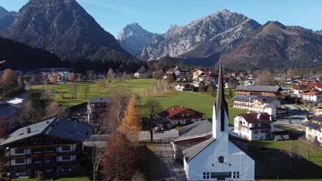 Church-and-houses-in-Austrian-village-Pertisay-by-the-lake-of-Achensee-in-mountains