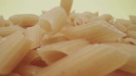 Falling-raw-half-furrowed-pens-or-mezze-penne-rigate-Italian-pasta