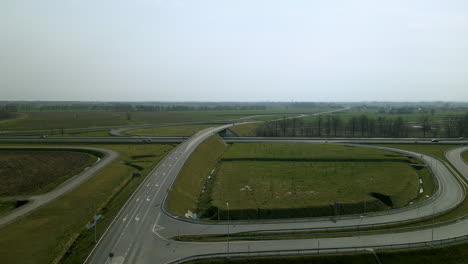 Aerial-view---drone-ascend-over-infinity-road-interchange-at-highway-road-S7-Cdry-in-Poland-daytime-sunny-weather