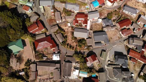 Overhead-top-down-aerial-flight-over-small-Japanese-village-with-houses-and-road
