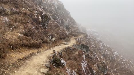 A-dirt-trail-in-the-Himalayan-Mountains-of-Nepal-in-the-dense-fog-of-the-early-morning
