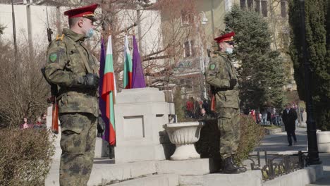 Two-soldiers-with-weapons-in-camouflage-uniform-wearing-anti-covid-masks-at-memorial-parade-service-on-Bulgaria-Independence-day