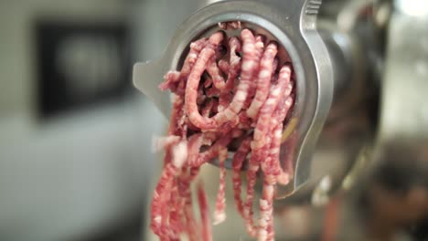 Grinder-machine-producing-minced-meat,-close-up