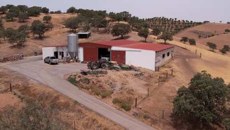 Aerial-View-Over-Farm-Warehouse-In-The-Countryside-Of-Alentejo,-Portugal---drone-shot