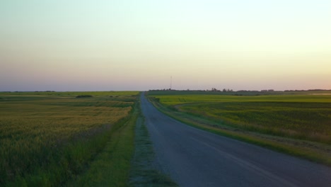 Gravel-road-in-the-summer-at-dusk-in-the-countryside