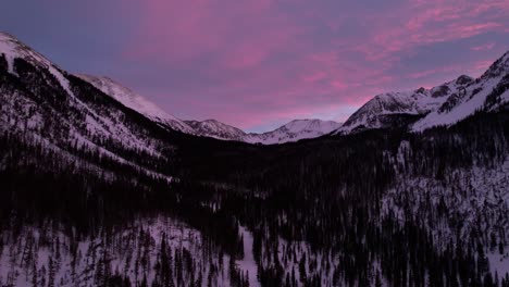 View-of-a-valley-between-two-snowy-mountains-during-colorful-sunset