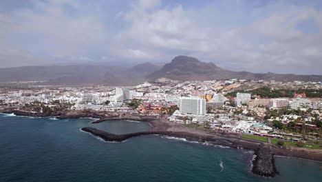 Aerial-orbit-view-of-Playa-de-las-Americas-coastline-in-Tenerife