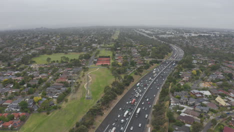 Static-aerial-perspective-with-heavy-traffic-running-both-ways-on-M1-highway-in-Melbourne,-Australia