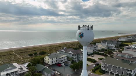 Aerial-video-of-flight-over-hotels-at-beach-and-water-tower