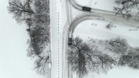 Aerial-view-of-roads-during-a-winter-snow-storm-in-Minnesota-cars-driving
