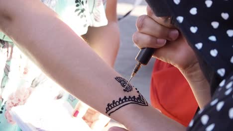 4K-Aufnahmen-Eines-Traditionellen-Henna-Tattoos,-Das-In-Den-Straßen-Von-Marrakesch-Gemacht-Wird