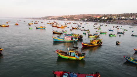 Aerial-forward-view-of-many-Vietnamese-fishing-boats-standing-in-the-bay