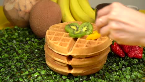 Topping-adding-peach-to-a-waffles-slow-motion-fruits